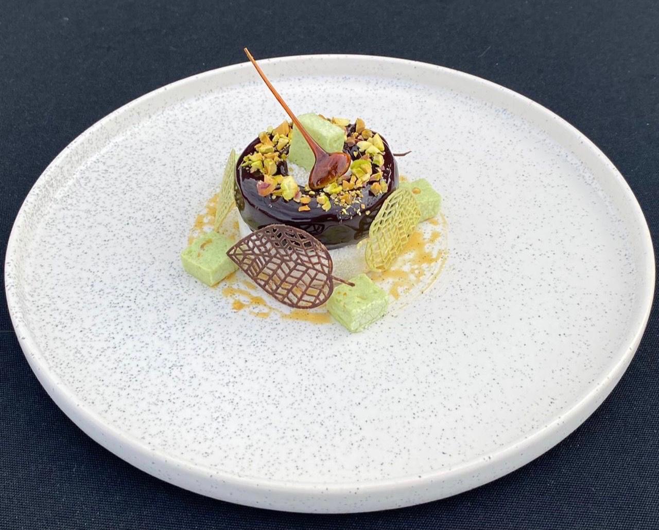 Dark chocolate and pistachio dessert with caramel and marshmallow
