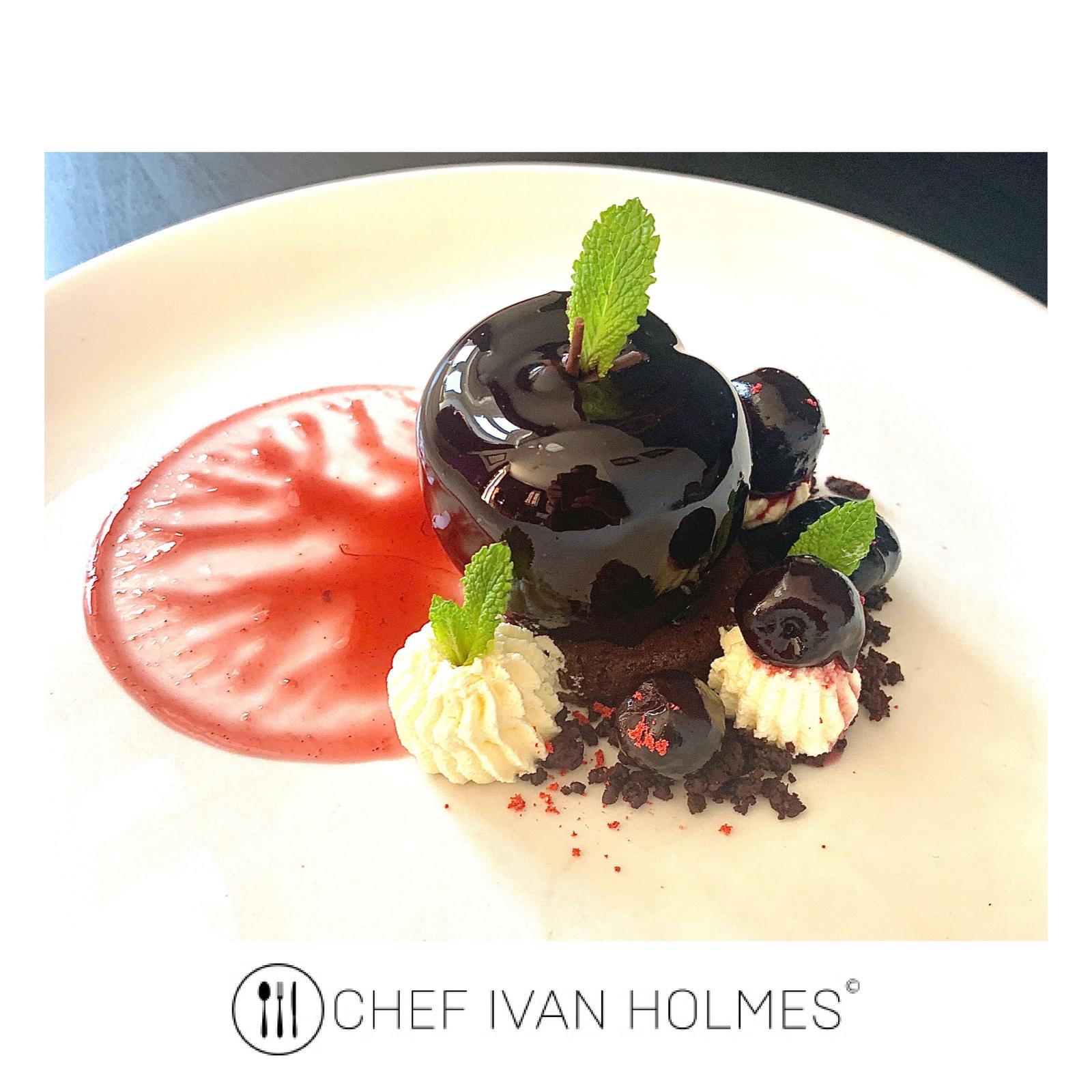 Chocolate and cherry dessert with mint and berry coulis