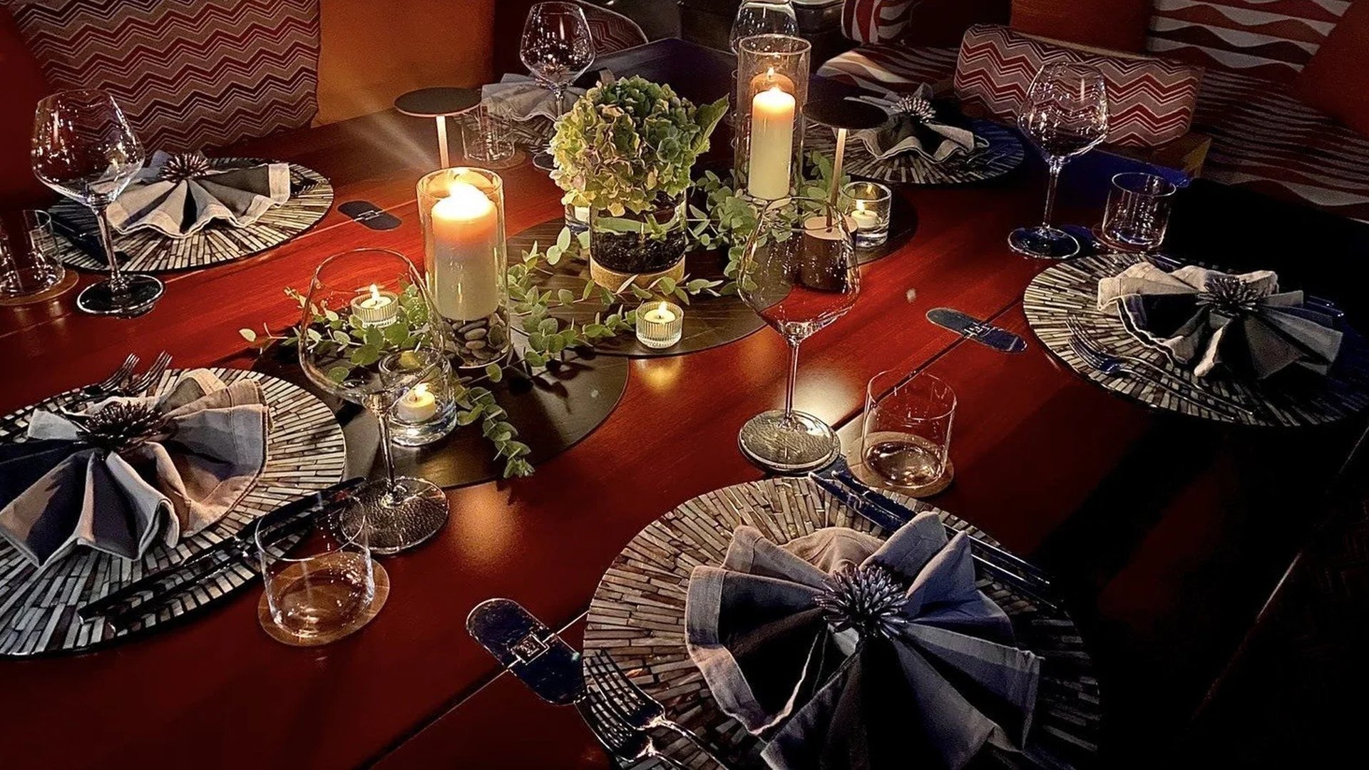 A long table laid with candles and glassware for a private dinner